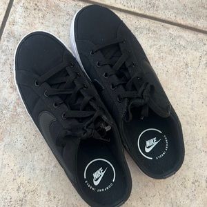 Black Nike slip-on tennis shoes. New.
